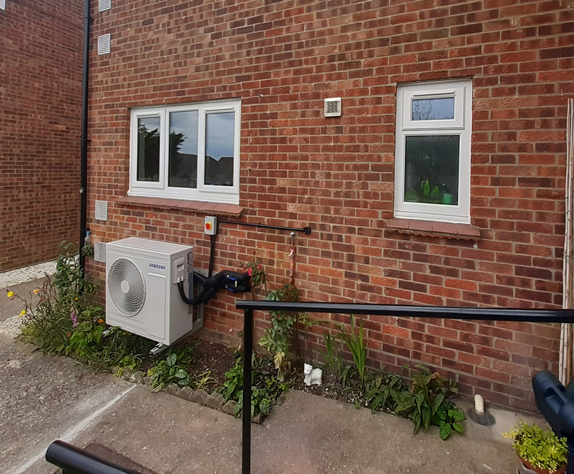 front of home with heat pump